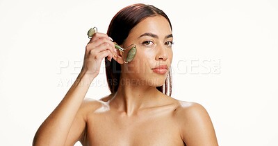 Buy stock photo Woman, jade roller and face in studio for skincare, mock up space or circulation on background. Person, model and beauty with portrait, dermatology and massage for lymphatic drainage in Colombia