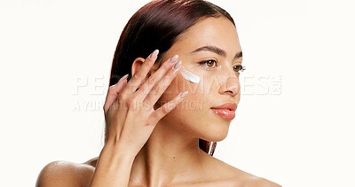 Buy stock photo Beauty, skincare and girl with face cream in studio for skin hydration, healthy glow or hyaluronic acid. Cosmetics, woman and apply product on white background for SPF, dermatology and mockup space