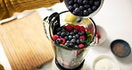 Kitchen, fruit and hands with blender for smoothie in home for healthy drink, diet and detox. Above, protein shake and person with ingredients, food and berries for nutrition, wellness and vitamins