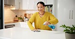 Happy, woman and cleaning counter with spray for germ disinfection, dirt removal and housekeeping. Home, person and chemical product in kitchen for household maintenance, hygiene and domestic chores