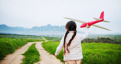Buy stock photo Back, child and play with airplane outdoor for fun activity, flying games and explore meadow. Space, girl and toys in air for freedom, weekend break and sensory development on holiday in countryside