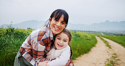 Buy stock photo Portrait, grass field and mother hug child for bonding, love and connection for countryside vacation. Farm holiday, space and happy woman with support for girl, embrace and outdoor for relationship