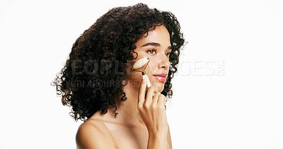Buy stock photo Woman, jade roller and skincare with facial in studio for anti aging on a white background. Female person, model or makeup with beauty tool for lymphatic drainage or face massage on mockup space