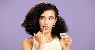 Buy stock photo Woman, beauty and lip gloss with product in studio for cosmetics on a purple background. Female person, model or applying lipstick with container for glow up shine, color and texture on mockup space