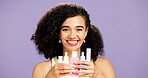 Happy woman, portrait and skincare with beauty cosmetics for dermatology on a purple studio background. Female person, smile and hydration with products or retinol for vitamin C or facial treatment