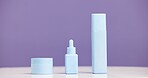 Bottle, container and marketing for beauty in studio with mockup, space or promotion on purple background. Skincare, product and marketing for cosmetic care, dermatology selection and presentation