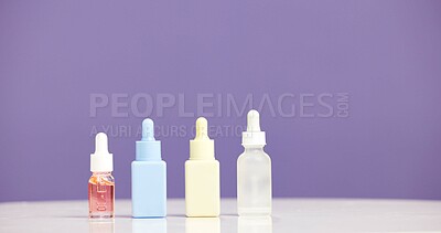 Buy stock photo Bottle, serum and marketing for skincare in studio with mockup, space or promotion on purple background. Beauty, product and advertising for cosmetic care, dermatology selection and presentation