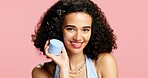 Beauty, container and portrait of happy woman in studio for cream or lotion recommendation. Moisturizer, skincare and smile of model person isolated on pink background for cosmetic product marketing