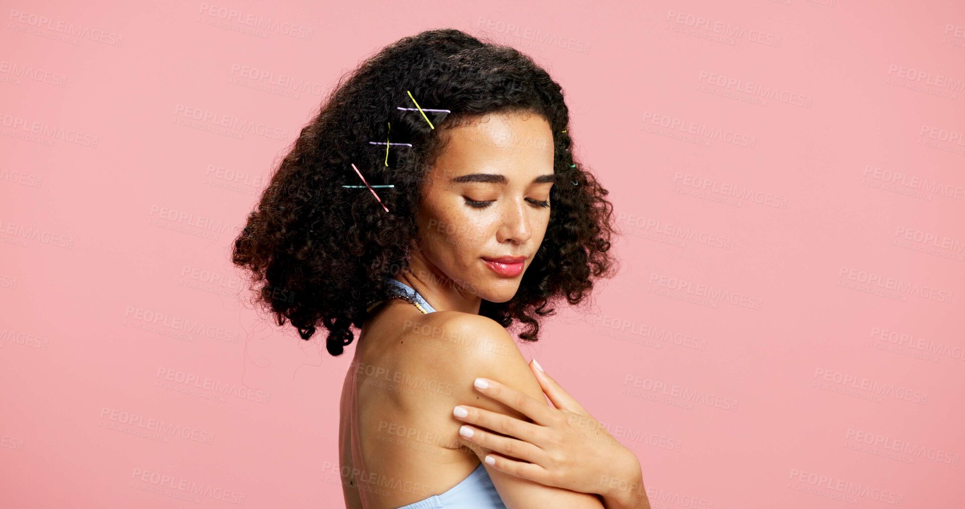 Buy stock photo Shine, skincare and woman in studio, beauty and dermatology with curly hair on pink background. Mockup space, gen z or person with wellness, glow or cosmetics with hairstyle, healthy skin or pride