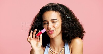 Buy stock photo Cosmetics, portrait and woman with red lip gloss in studio, color product and moisturizing benefits for shine. Lipstick, beauty aesthetic and person wink with makeup, mockup space and pink background