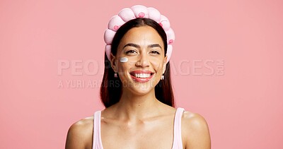 Buy stock photo Moisturizer, skincare and portrait of woman in studio with natural, beauty and facial routine. Happy, hydration and female person with face lotion, spf or sunscreen for glow by pink background.