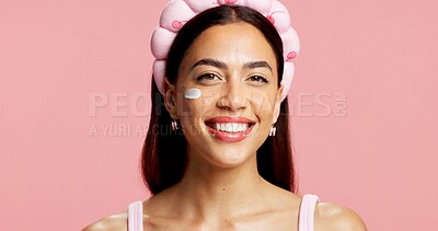 Buy stock photo Portrait, woman and sunscreen for skincare in studio for hydration, healthy skin and collagen. Smile, person and cream for moisturizing, smooth textures and spf treatment for shine on pink background