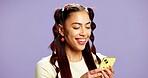 Fashion, scroll or woman in studio with phone, app browse or internet search for styling tips. Digital, smile or girl on purple background with tech, gen z or blog inspiration for trendy aesthetic.