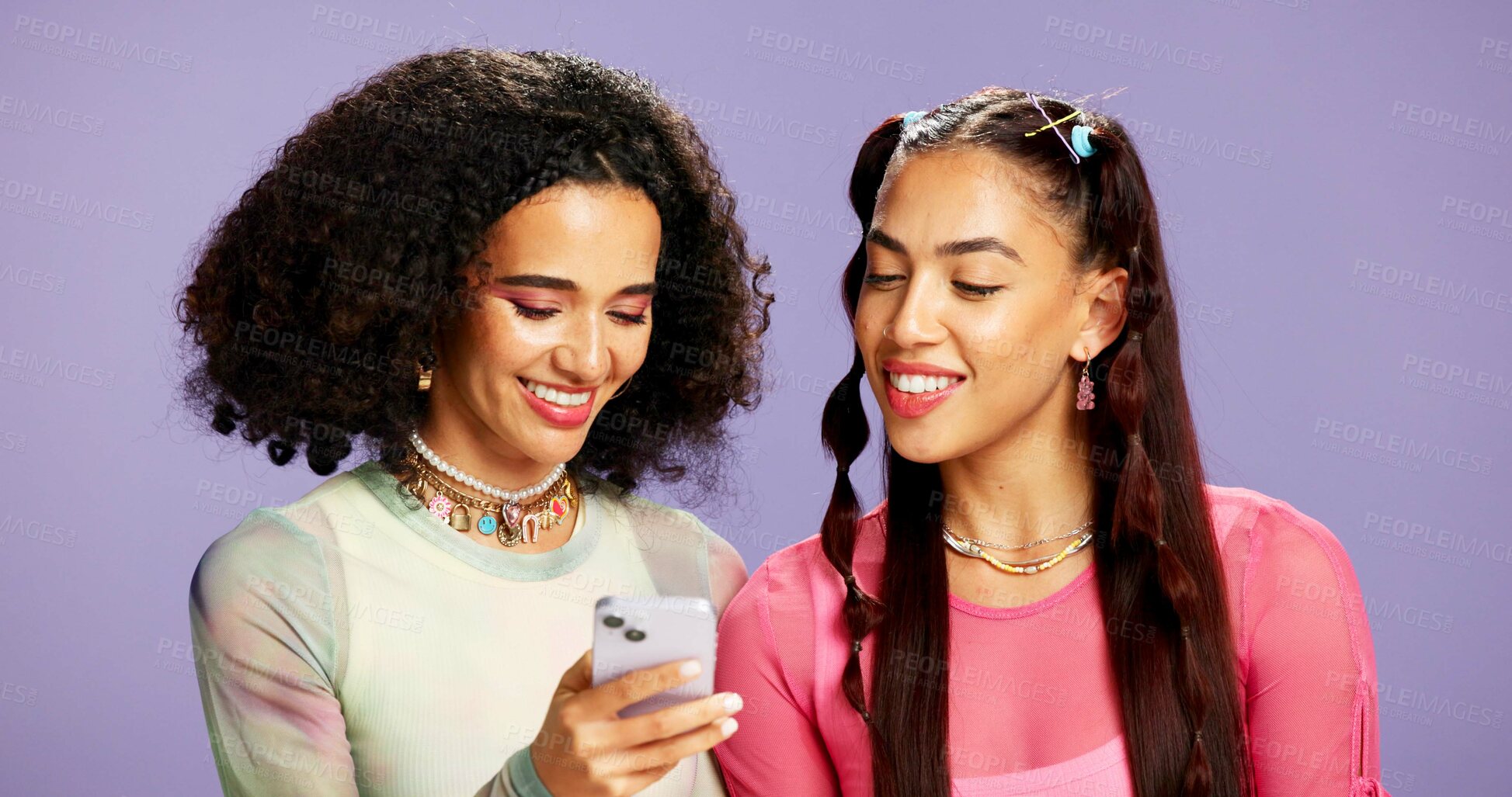 Buy stock photo Smartphone, friends and women in studio, internet and smile with email on purple background. Gen z, mobile user or people with cellphone, network and digital app for communication and online chatting