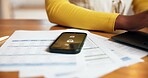 Alarm, documents, phone screen with person at desk in home office for accounting or finance. Alert, paperwork and remote work with mobile notification on table in apartment for communication