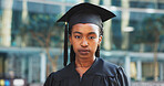 Black woman, student and graduation in city with portrait for education, achievement or success at campus. African person, cap and gown for ceremony, learning and scholarship at college in Nigeria