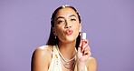 Lipgloss, pout and portrait of woman in studio for cosmetics, peptide treatment and beauty maintenance. Self care, glow and makeup product with person on purple background for shine, kiss and gen z