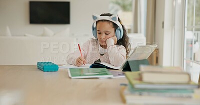 Buy stock photo Home, knowledge and child with headphones, writing and listening to audio lesson, elearning or study. Student, serious and girl with tech for homework, growth and development with online education