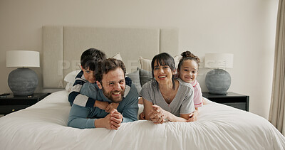 Buy stock photo Parents, children and portrait on bed with play, smile and bonding for love with pyjamas at house. People, mom and dad with kids, happy or relax in morning, care and laugh at family home in Spain