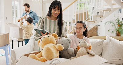 Buy stock photo Mom, girl and tablet with boxes in new home with toys, smile and checklist for moving with real estate. People, mother and daughter on tech, app or happy for unboxing with teddy bear at family house