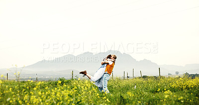 Buy stock photo Love, couple and hug on field for celebration, care and romance with space on holiday. Embrace, man and woman in countryside with flowers on vacation, anniversary and bonding together outdoor