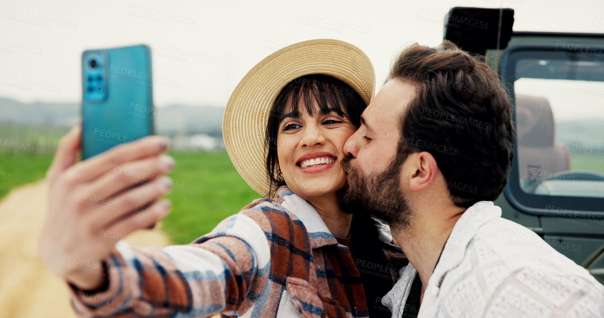 Buy stock photo Travel, couple and kiss in selfie at car for road trip memory, social media post and journey break. Bonding, happy people and photography in countryside for romantic getaway or profile picture update