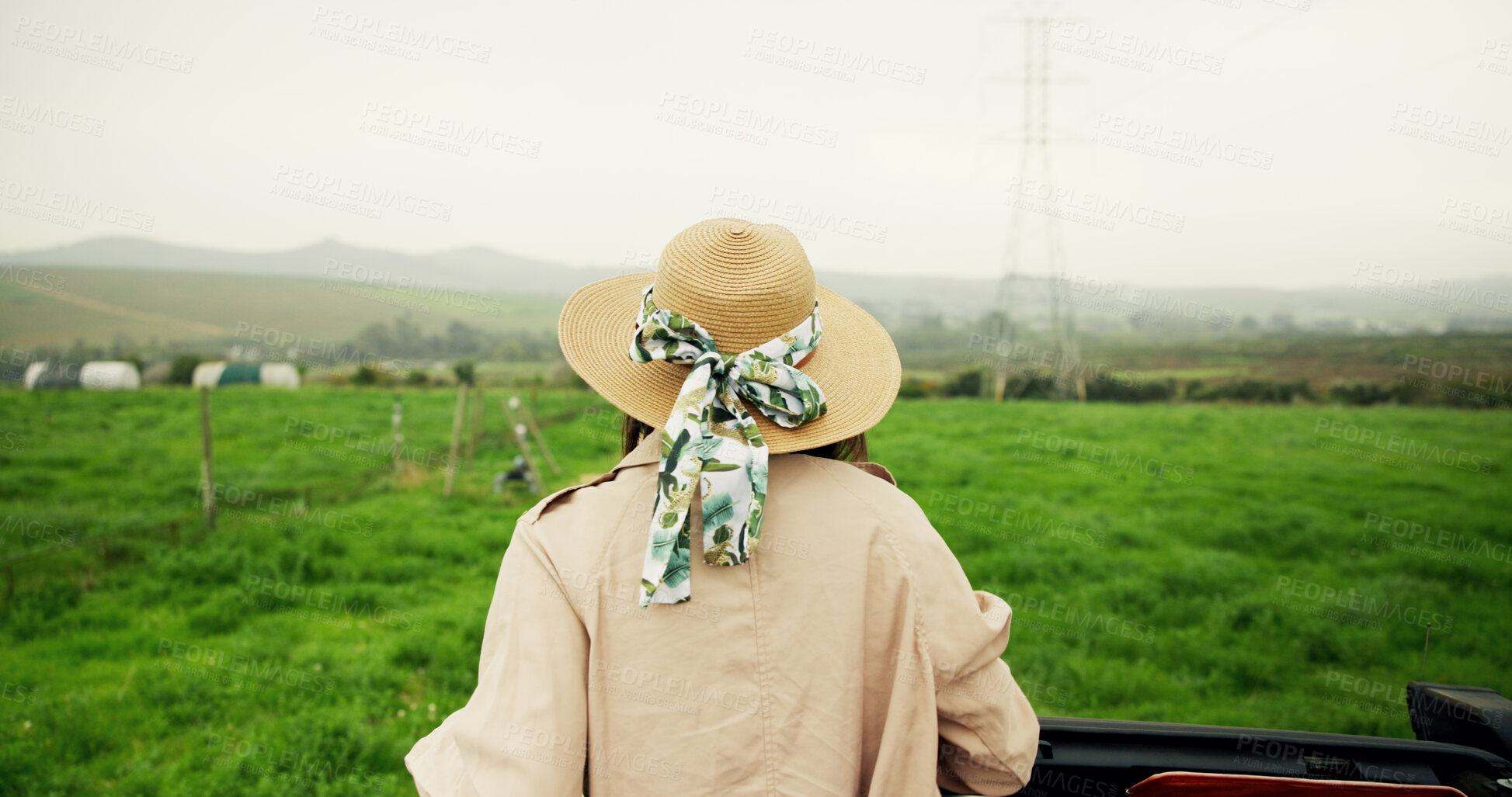Buy stock photo Travel, back and person on field with view, agriculture and scenery on holiday trip. Tourism, mountain and tourist in countryside with hat, farming vacation and outdoor journey in rural getaway.