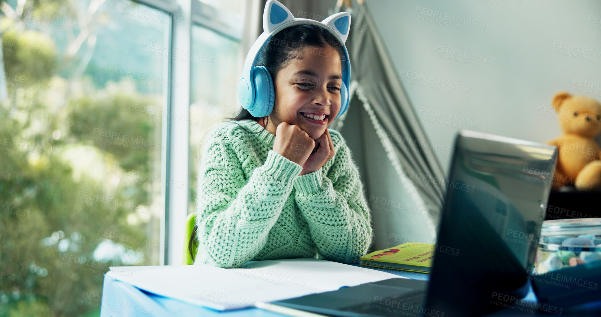 Buy stock photo Education, homework and laptop with girl student at desk in home for learning or video study. Computer, headphones or online course with child learner in apartment for assessment, knowledge or lesson