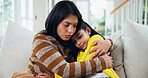 Mom, girl and crying with hug on sofa, comfort and support for mental health in lounge at apartment. People, mother and daughter in living room for embrace, console or love on couch in family house