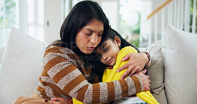 Buy stock photo Mom, girl and sad with hug on sofa, comfort and support for mental health in lounge at apartment. People, mother and daughter in living room for embrace, console or depression on couch in family home