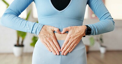 Buy stock photo Gut health, hands and heart on stomach, fitness center and motivation for weight loss goals and diet. Digestion, balance and person with self care symbol, wellness and sign on belly in pilates studio