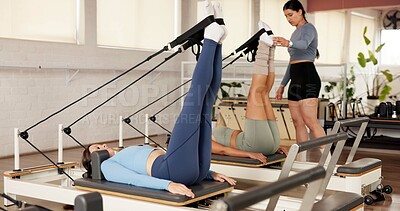 Buy stock photo Reformer, fitness and women in studio, stretching and pilates class with resistance. Healthy people, machine and group in wellness center, instructor and endurance with exercise, workout and routine