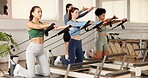 Reformer, fitness and women in studio, training and pilates class with resistance. Healthy people, machine and group in wellness center, equipment and endurance with exercise., workout and stretching