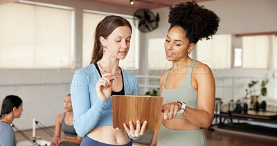 Buy stock photo Fitness, clipboard and women in studio, talking and support with pilates schedule. People, gym owner and coach with documents, exercise and checklist with recruitment, agreement and sign up