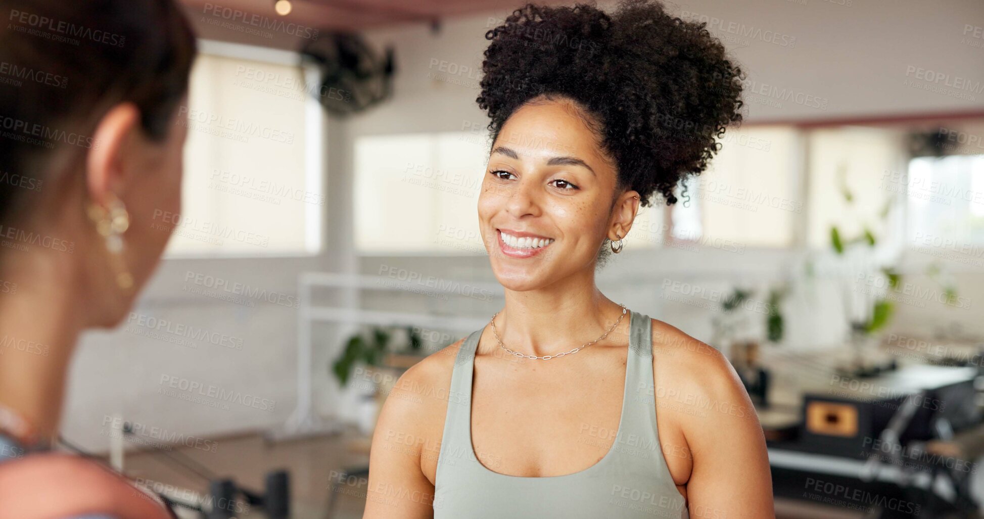 Buy stock photo Women, personal trainer and talking to client in gym, conversation or listening to positive feedback. Happy, people and instructor with fitness tips, advice and discussion on break in health club