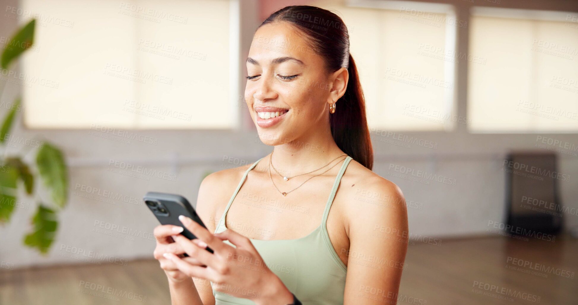 Buy stock photo Phone, smile and woman in yoga studio typing for communication with online app. Fitness, gym and female person with technology for networking, wellness contact and social media in pilates class