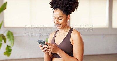 Buy stock photo Phone, smile and hands of woman in pilates studio typing for communication with online app. Fitness, gym and female person with technology for networking, contact and social media in yoga class