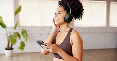 Buy stock photo Phone, music and happy woman in studio for fitness, streaming podcast or listening to sound. Mobile, health club and person with headphones for internet audio, wellness and radio on exercise break