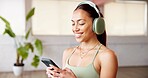 Phone, smile and headphones with woman in yoga class for podcast with online app. Fitness, gym audio and female person with technology for networking, contact and social media in pilates studio