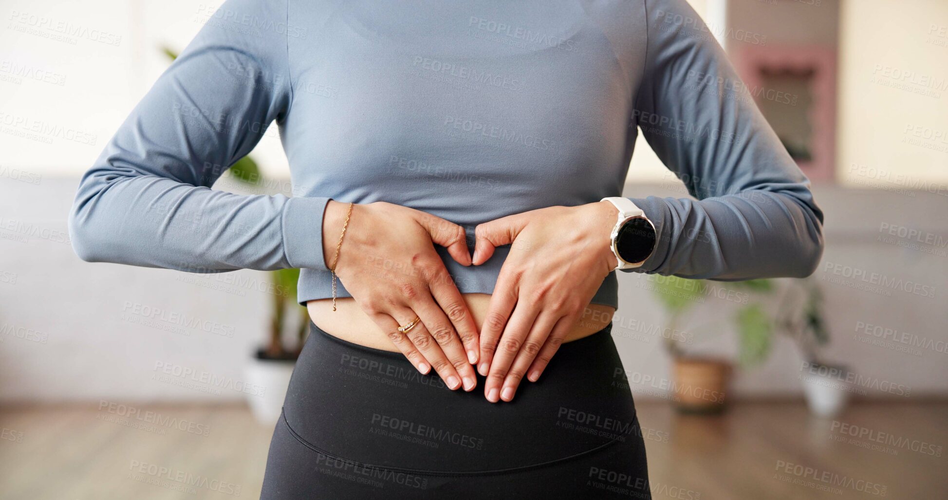 Buy stock photo Fitness, stomach and person in gym with heart hands, gut health and inspiration for body goals. Sport, belly and athlete in studio with emoji, weight loss and digestion support in wellness routine.
