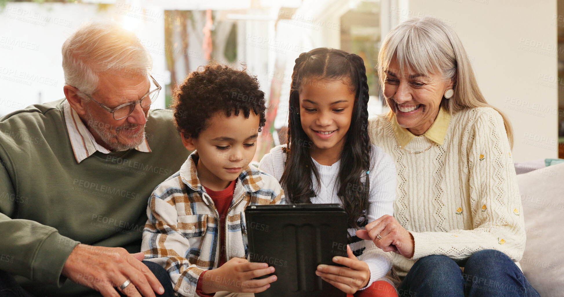 Buy stock photo Tablet, relax and grandparents with children on sofa in home for watching movie, series or show. Happy, digital technology and senior people with kids for streaming film together in living room.