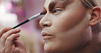 Drag performer, cosmetic or brush in dressing room for stage preparation, identity or profile. Person, makeup transformation or backstage for beauty, self expression or artist with creative alter ego