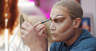 Buy stock photo Drag artist, mirror and makeup backstage for beauty, individuality or makeover. LGBTQ performer, person and cosmetics application with brush for preparation, eyeshadow or aesthetic in dressing room