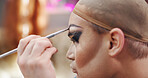 Drag artist, brush and makeup for beauty, self expression and makeover in dressing room. LGBTQ performer, person and apply cosmetics for preparation, eyebrow product and aesthetic transformation