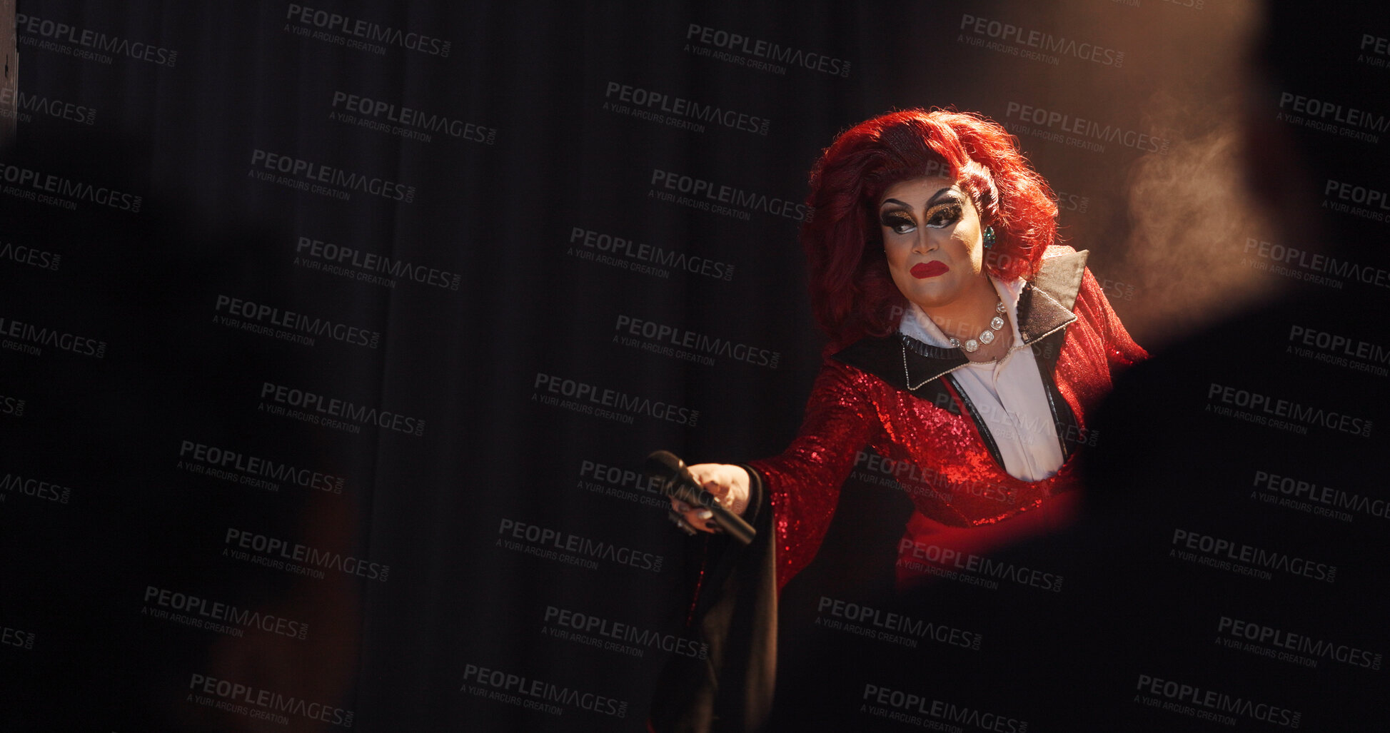 Buy stock photo Person, drag artist and mic on stage for performance, hosting show and audience engagement. Performer, spotlight and space for live entertainment, theater event and unique character for interaction
