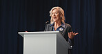 Election, politics or mature woman at podium with mic, democratic process or candidate speech at debate. Campaign message, persuasion or speaker with call to action, voter trust or public engagement