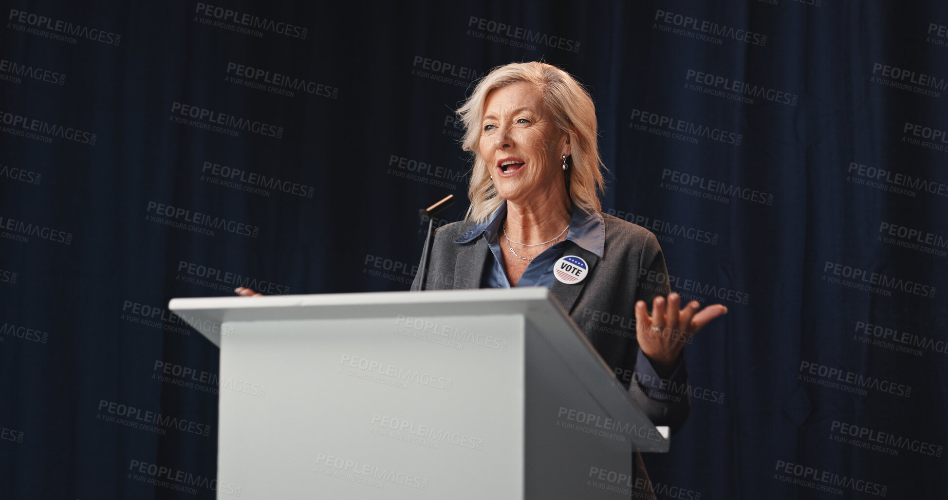 Buy stock photo Election, politics or mature woman at podium with mic, democratic process or candidate speech at debate. Campaign message, persuasion or speaker with call to action, voter trust or public engagement