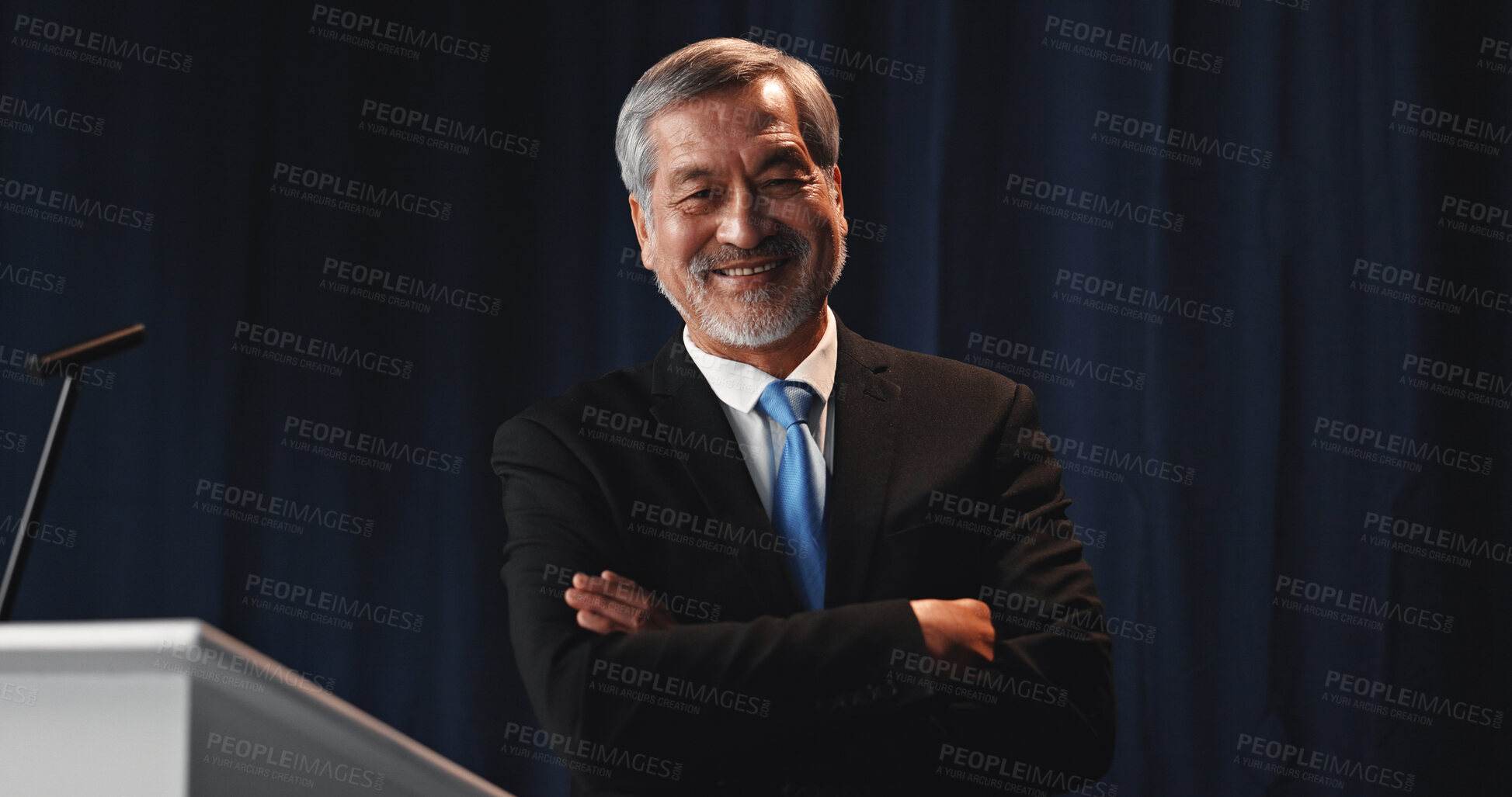 Buy stock photo Mature man, portrait and confident politician at podium for election campaign event, pride or happy. Smile, politics and Asian person as government speaker, arms folded or presidential candidate