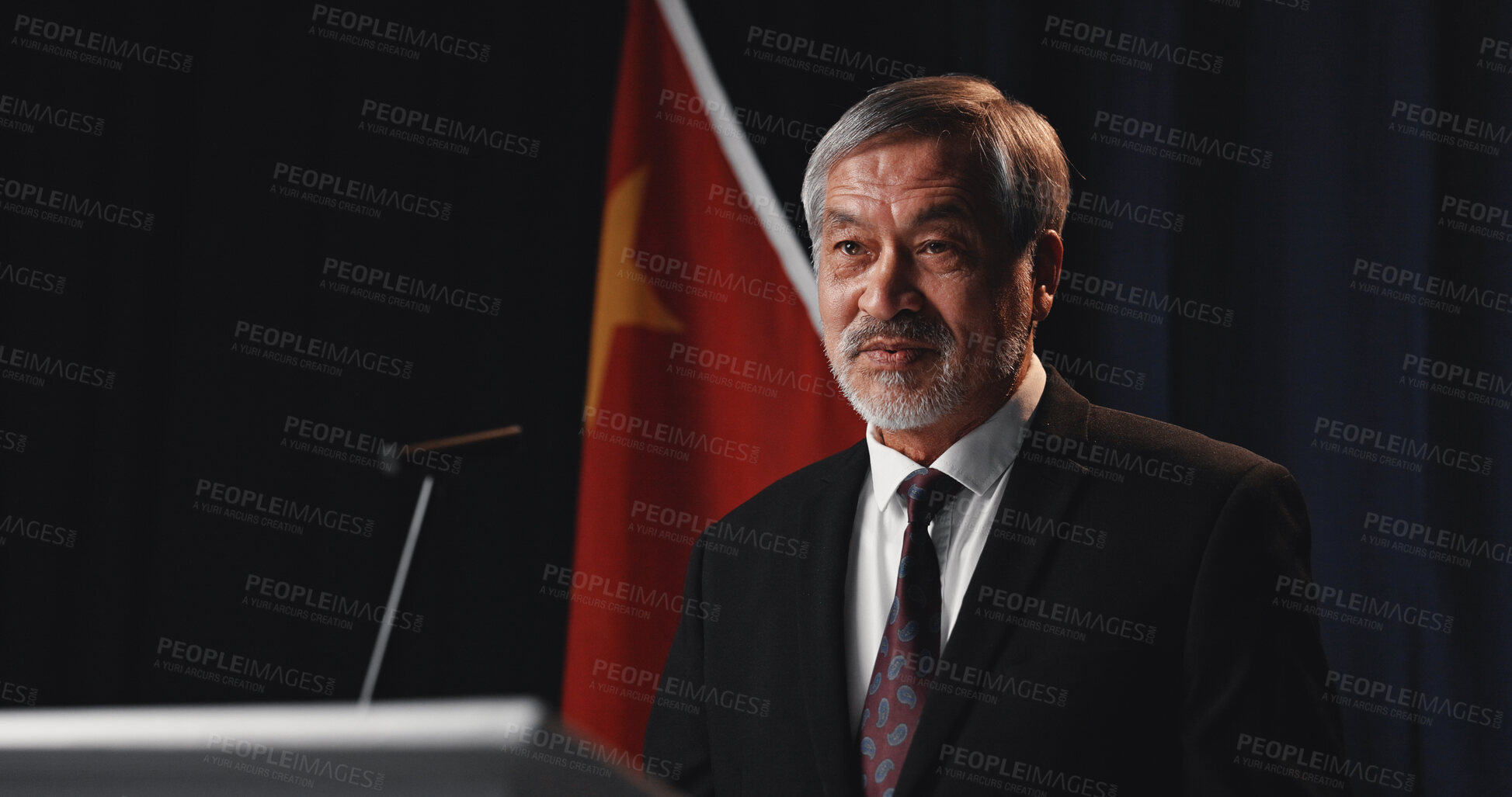 Buy stock photo Speech, politician and man with announcement, podium and stage for election, public speaking and pride. Mature person, presentation and speaker with feedback, democracy and convention in Vietnam