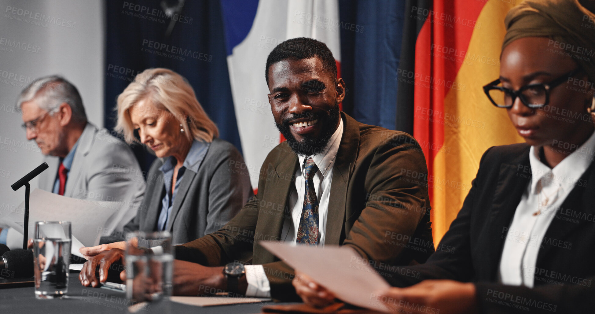 Buy stock photo Press conference, politics and happy man with government delegation or international panel. Summit, people and portrait of politician with group at event for diplomacy, global forum or policy expo